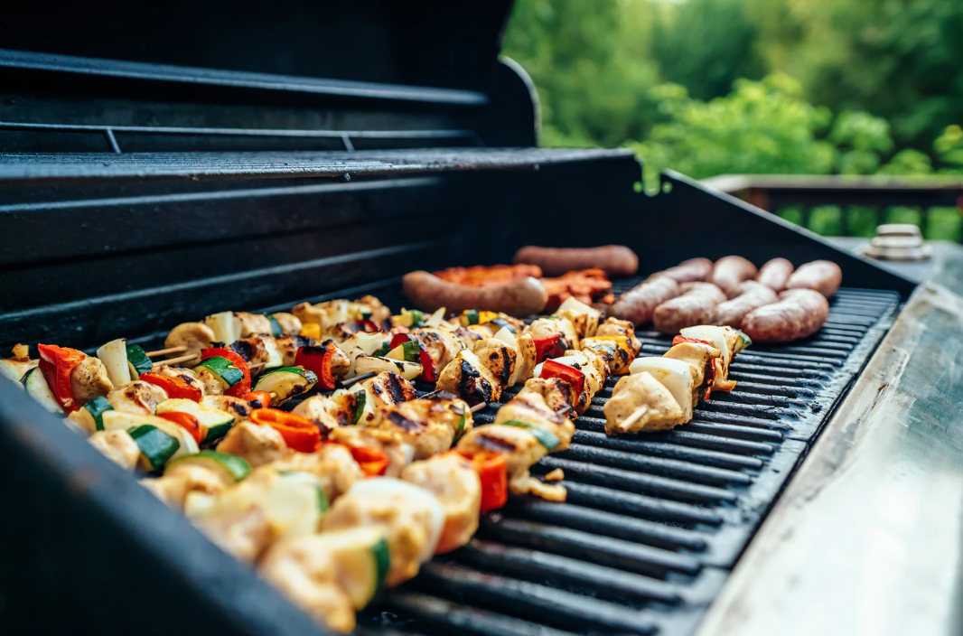 Photo of Kabobs and Hot Dogs Being Grilled 